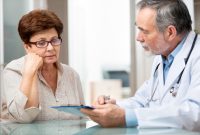 doctor talking to his female patient at office