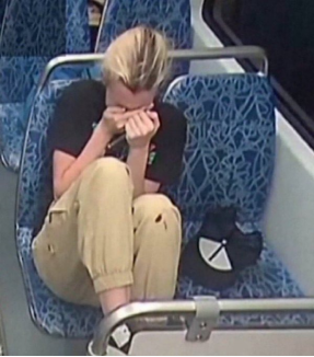 Surveillance-style image of a distressed woman sitting alone on public transport, symbolizing fear, violence, and societal breakdown.