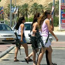 Three women walking down a street carrying large rifles