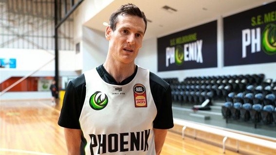 Professional basketball player, Ben Madgen, being interviewed on an indoor court, associated with discussions on myocarditis and athletic health after mRNA vaccination.