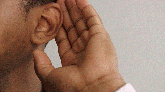 Person cupping a hand behind their ear to listen more closely.