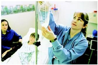 Healthcare professional administering an intravenous infusion.