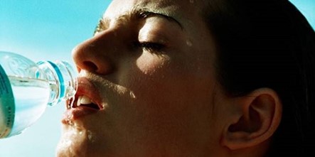 Woman drinking bottled water.