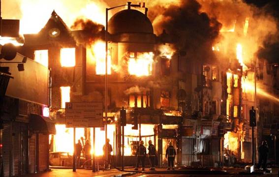 A property is on fire near Reeves Corner in Croydon, south London, Tuesday, Aug. 9, 2011. A wave of violence and looting raged across London and spread to three other major British cities on Tuesday,